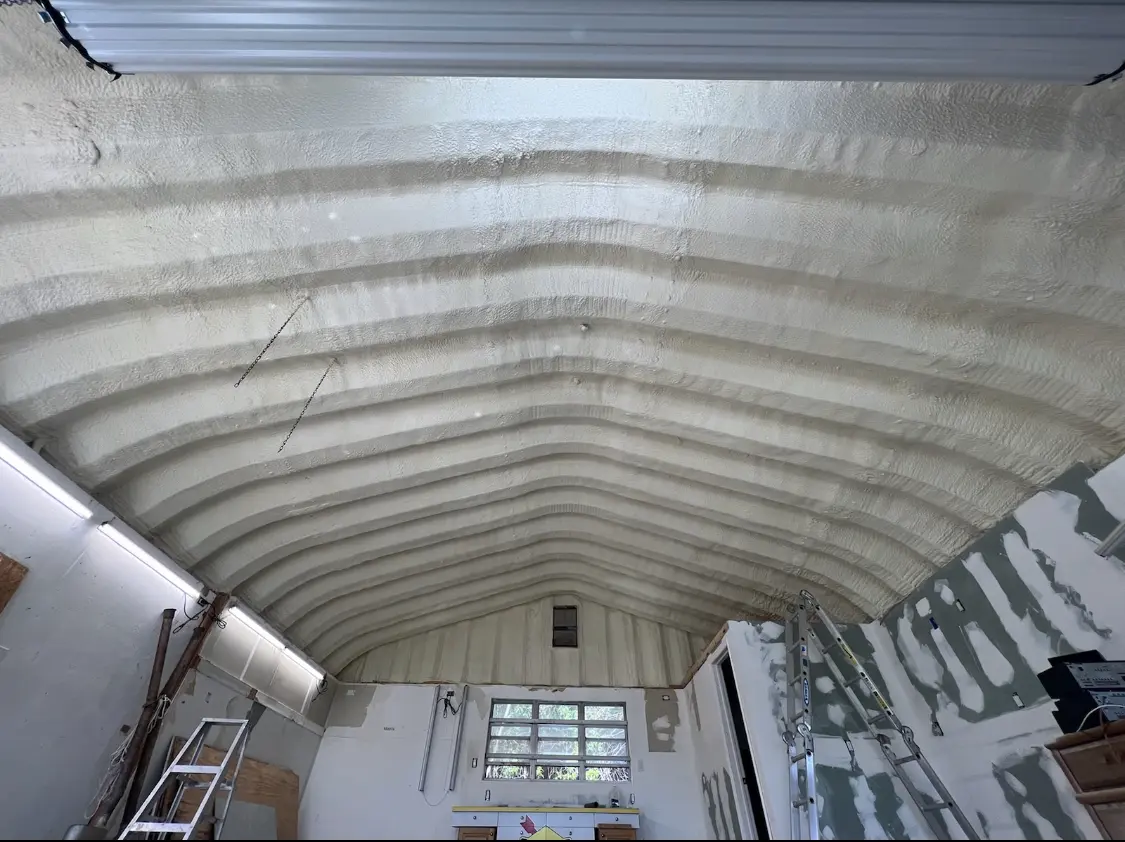 Spray polyurethane foam applied to the underside of a metal roof deck in Farmington